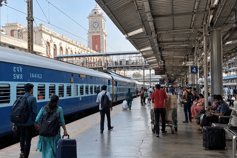 Passengers beside a train on a railway platform