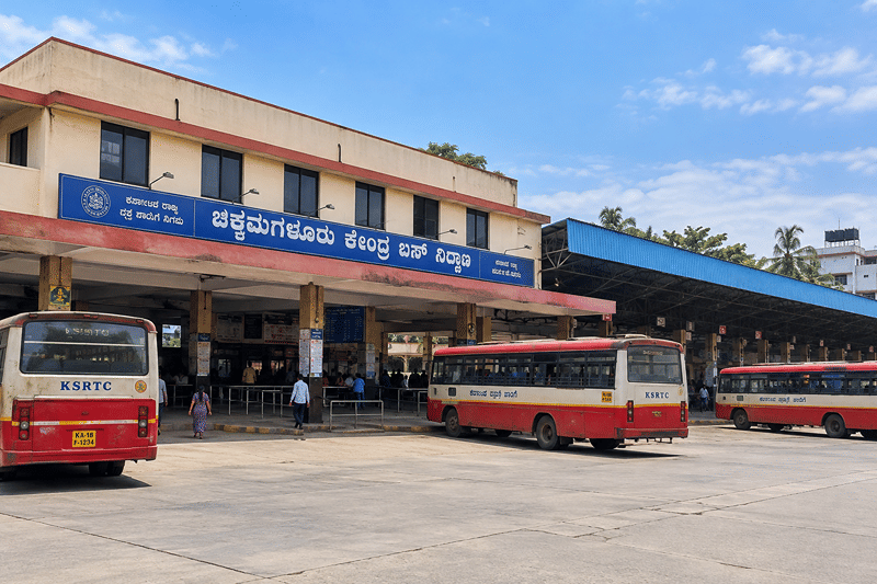 Red-and-cream KSRTC buses parked outside the Chikkamagaluru bus stand building