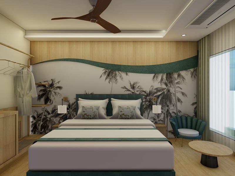 Round coffee table and armchair beside the window of a Deluxe Room | Shirgaonkar Beach Resort