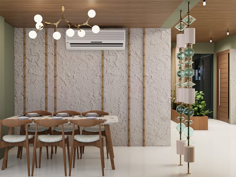 Table for 6 against a textured white wall under a globe chandelier | Shirgaonkar Beach Resort