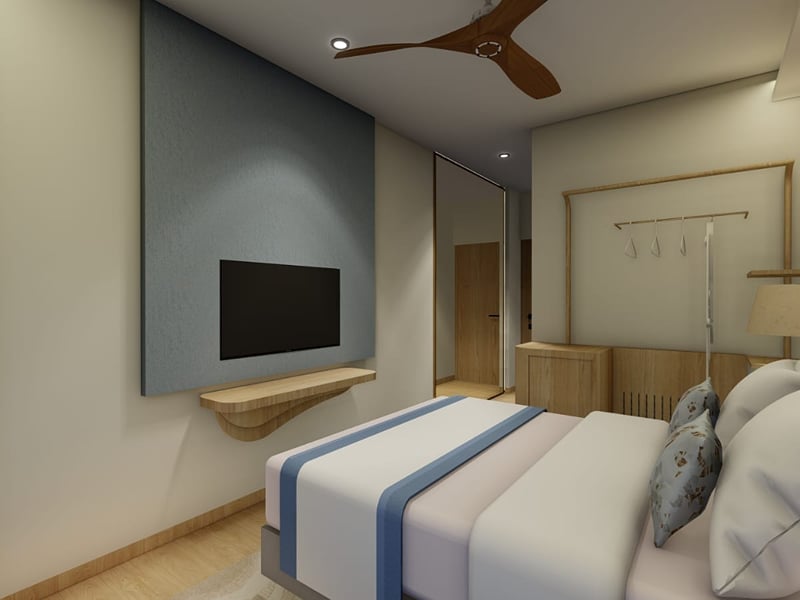 Sea View Room under warm evening lighting, with a television on a slate-blue panel | Shirgaonkar Beach Resort