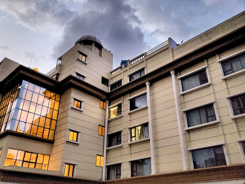 Hotel City Heart, Shirdi, facade at dusk with lights on