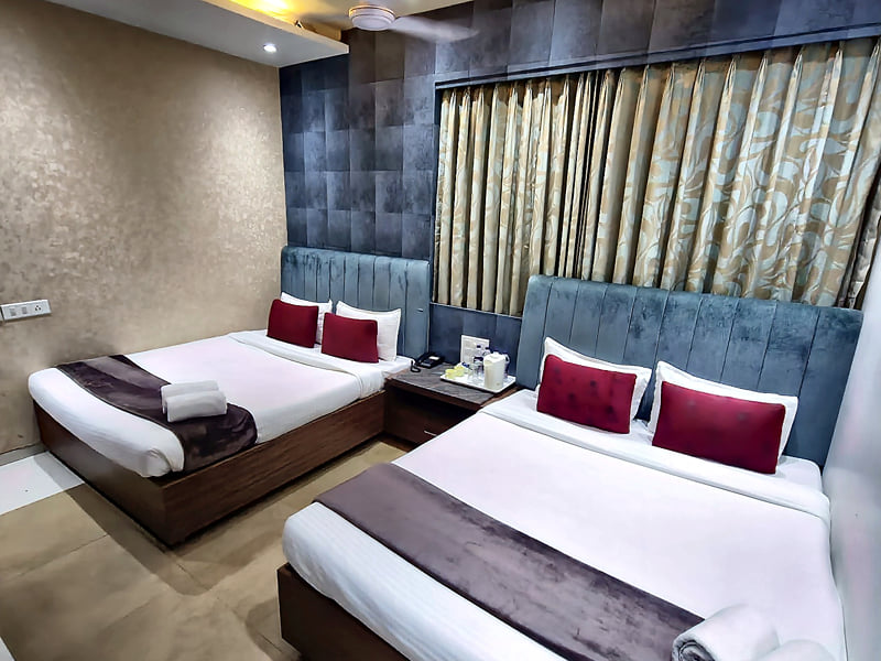 Premium Family Room double beds under a cove-lit ceiling