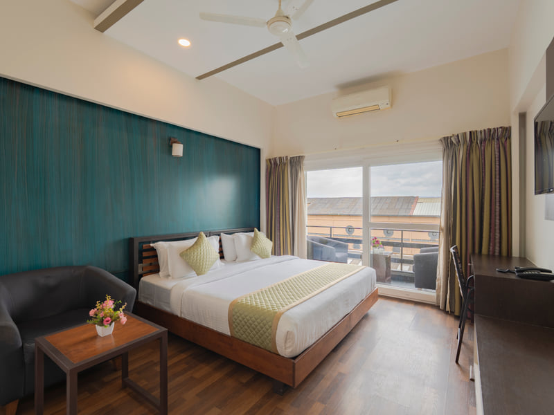 Guest room with a teal accent wall