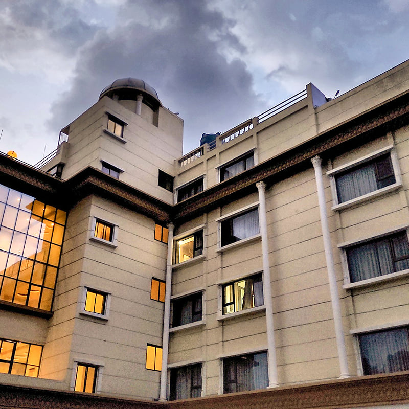 Hotel City Heart, Shirdi, facade at dusk with lights on