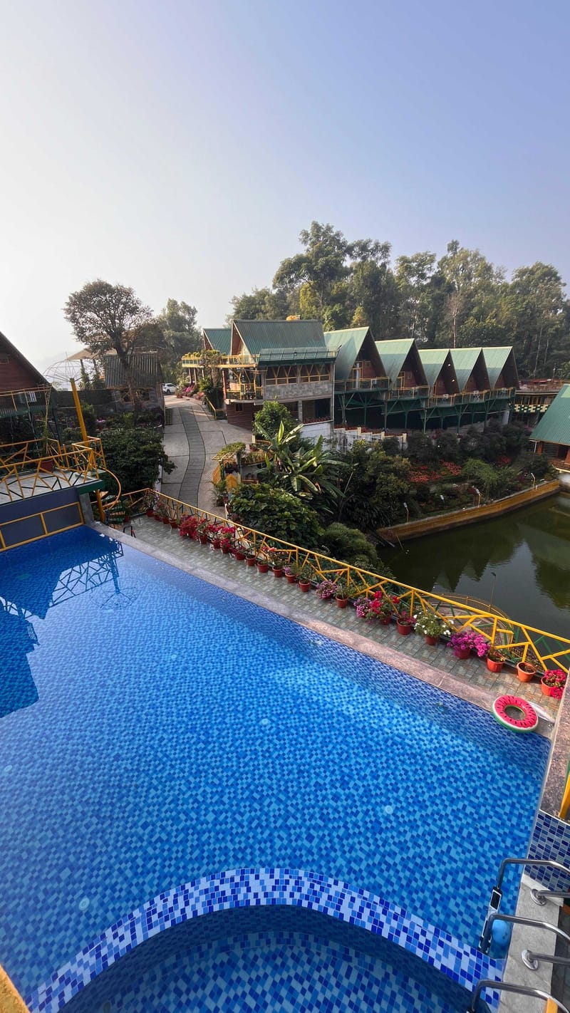 The pool deck looking towards the A-frame cottages and the lake