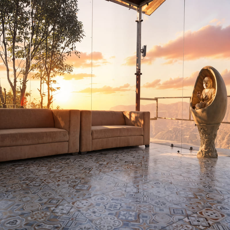 Reception lounge at Nazaara Nature Retreat with a Buddha statue accent and sofa seating framed by a sunset view