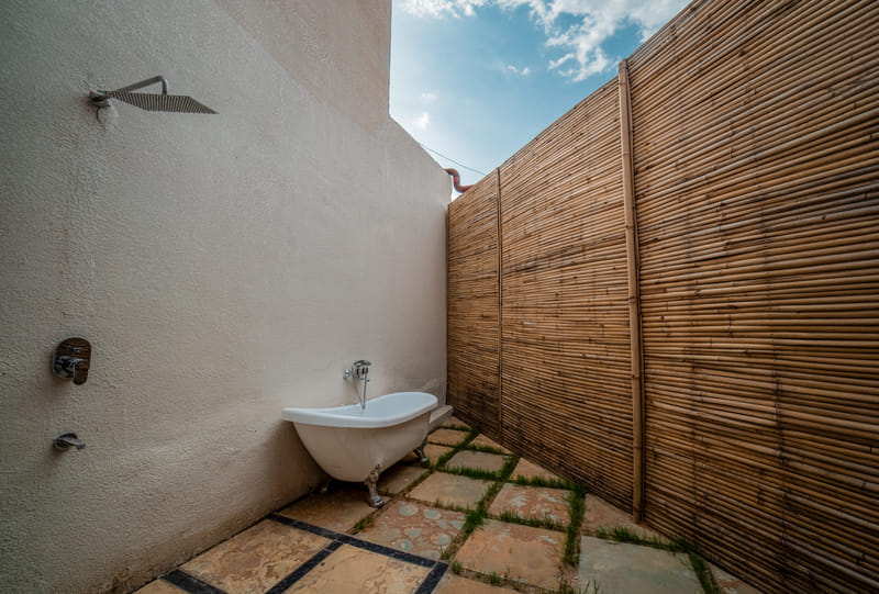 Close-up of the outdoor shower and tub on the patio of the Luxurious Cabana Cottage, Nazaara Hills Retreat, Udaipur.