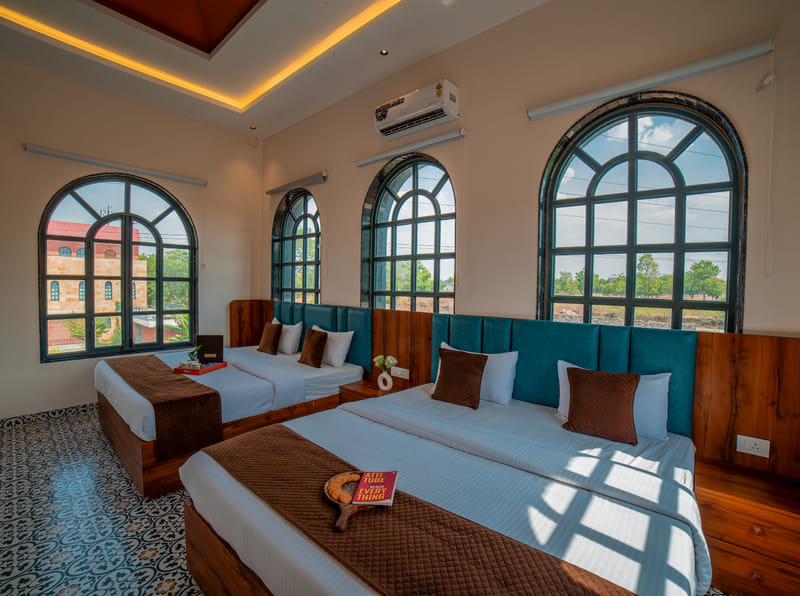 The Nazaara Family Suite bedroom at Nazaara Hills Retreat, Udaipur, set up with twin beds.