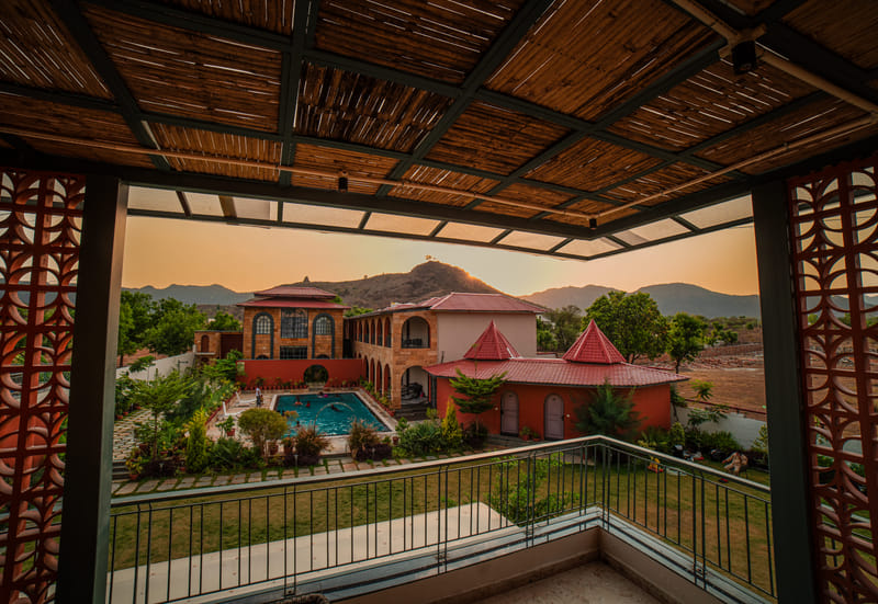Sunset view over the swimming pool and Aravalli hills at Nazaara Hills Retreat, Udaipur, special offer