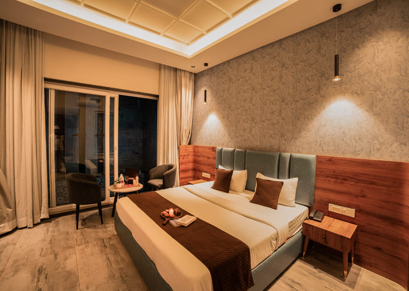The Premium Plunge Pool Room at Nazaara Hills Retreat, Udaipur, its private pool lit up at night.