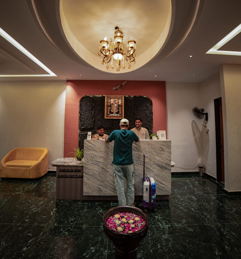 A guest checking in at the reception desk of Nazaara Hills Retreat, Udaipur.