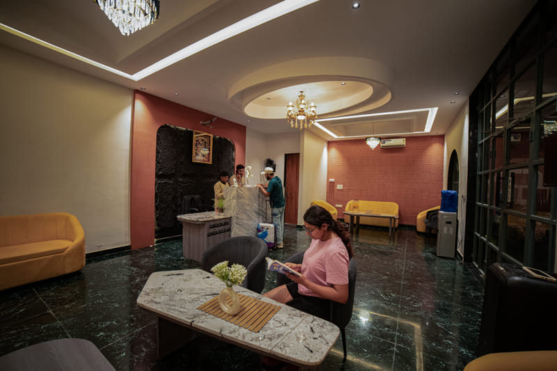 A guest reading in the reception lobby of Nazaara Hills Retreat, Udaipur.