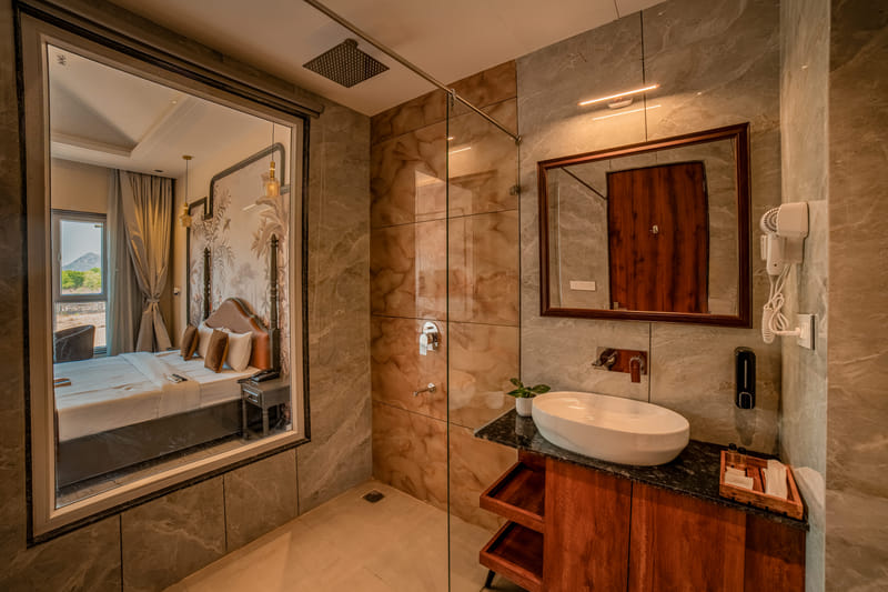 Superior Room bathroom at Nazaara Hills Retreat, Udaipur, with a shower cubicle and vanity counter.