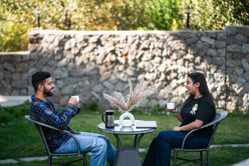 Guests enjoying coffee outdoors on the lawn at Nazaara Luxe Retreat