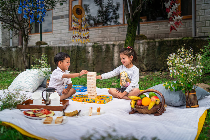 Children playing games on the lawn at Nazaara Luxe Retreat