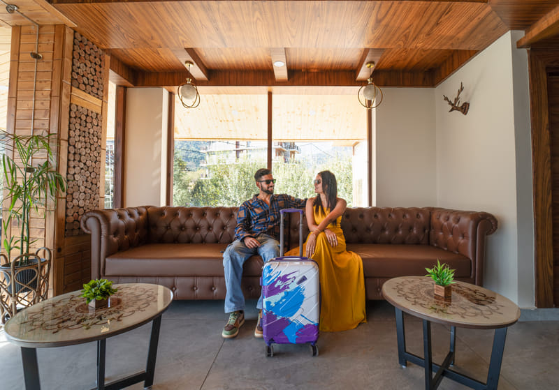 Guests seated in the lobby with their luggage at Nazaara Luxe Retreat