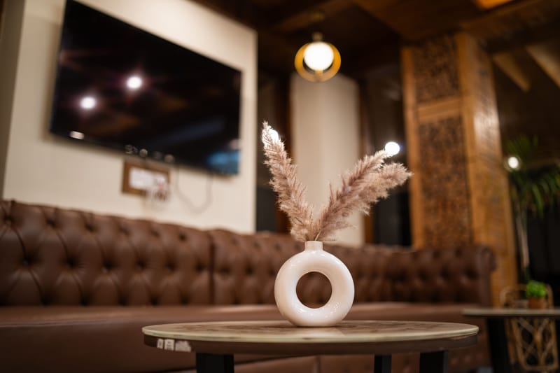 A softly lit lounge corner at Nazaara Luxe Retreat with seating arranged for guests to gather indoors