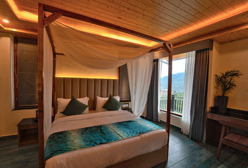 Close-up of the canopy drapes above the bed in a Luxurious Room at Nazaara Luxe Retreat