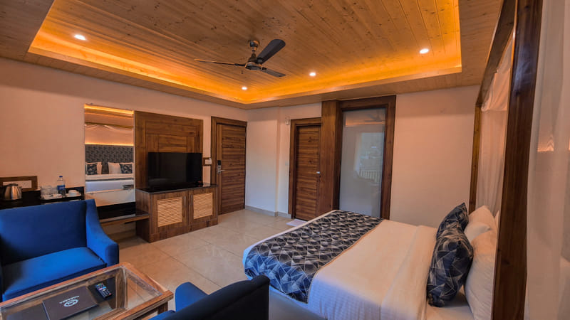 Luxurious Room entrance and television console at Nazaara Luxe Retreat
