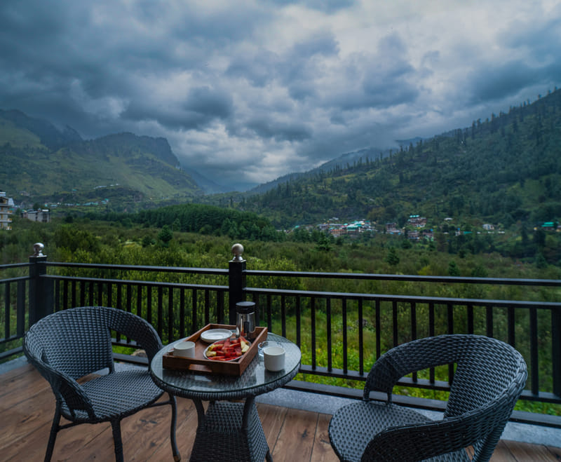Premium Room private balcony at Nazaara Luxe Retreat framing an open mountain view