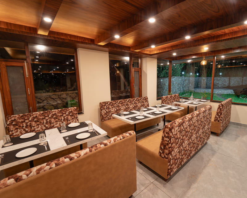 Restro & Café's dining room lit warmly for the evening at Nazaara Luxe Retreat