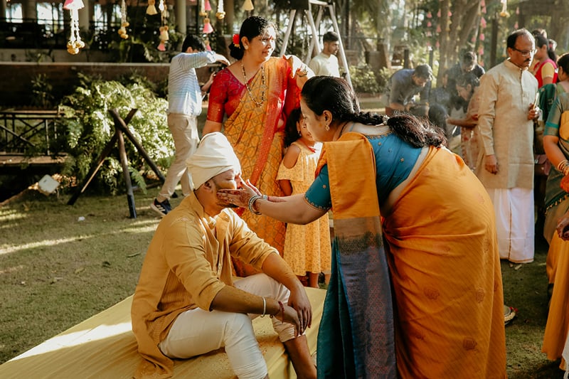 Guests in traditional dress gathered on a lawn for an outdoor family ceremony at The Garud Forest, Tadoba