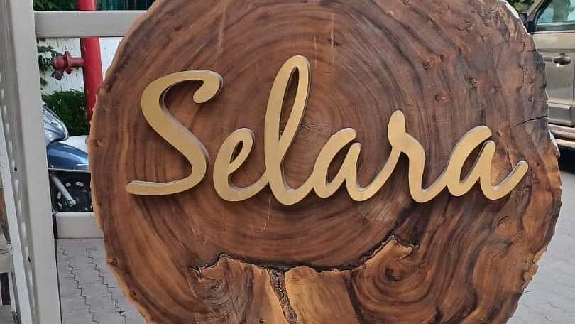 Signange of Selara on a wooden block - The Cindrella Hotel, Siliguri