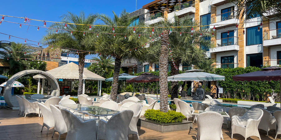 Poolside covers laid out beneath the palms