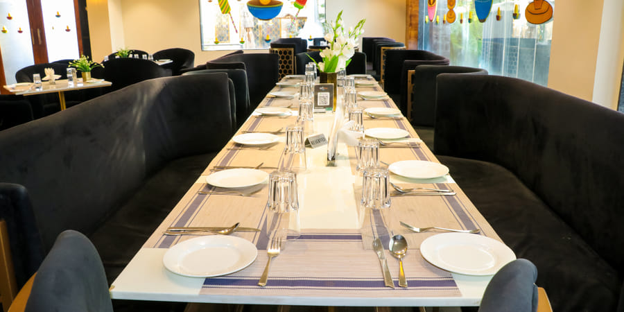 A long table laid with place settings
