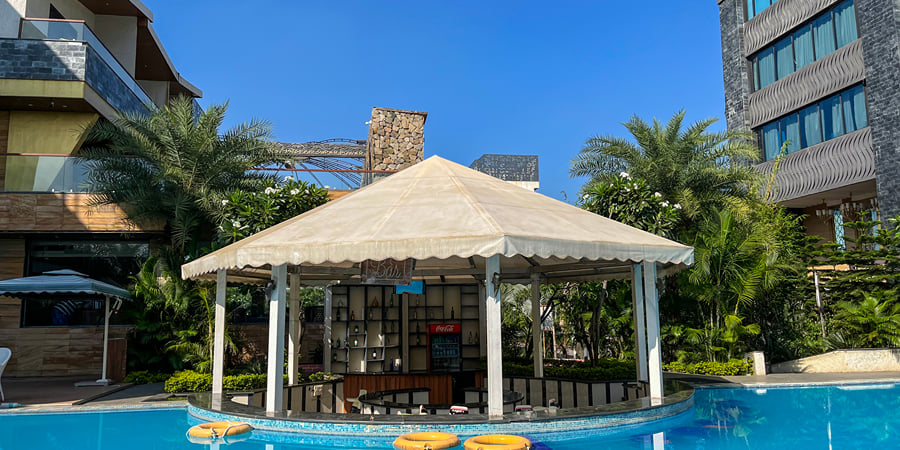White gazebo bar set in the swimming pool beside the Flamingo poolside restaurant
