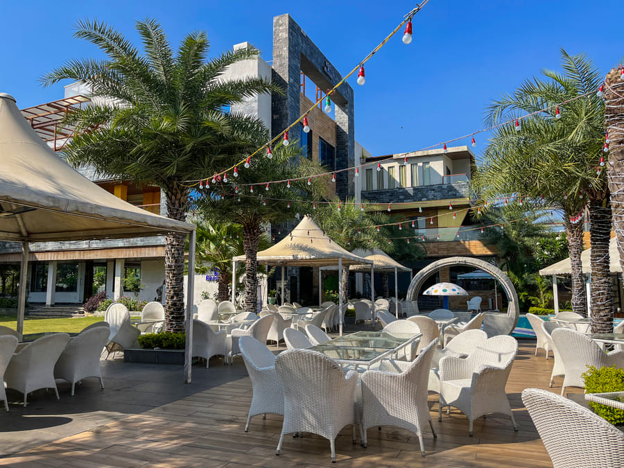 Flamingo, poolside tables beneath the festoon lights