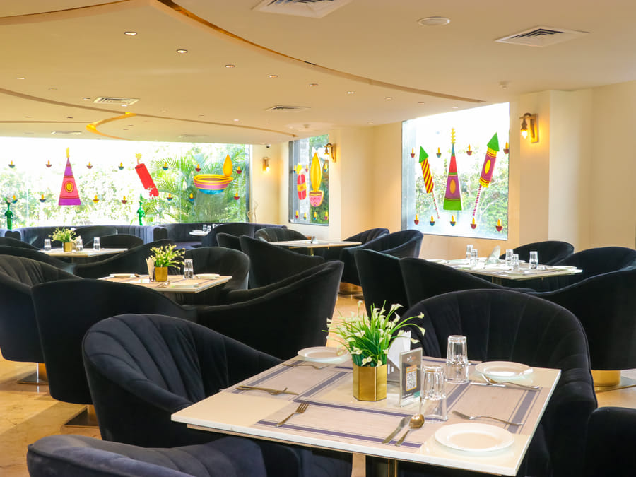 Zeus, marble tables and navy velvet chairs in the fine-dining room
