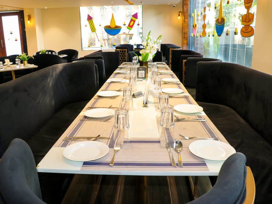 Skyline by Miraya, Zeus, A long table laid with place settings