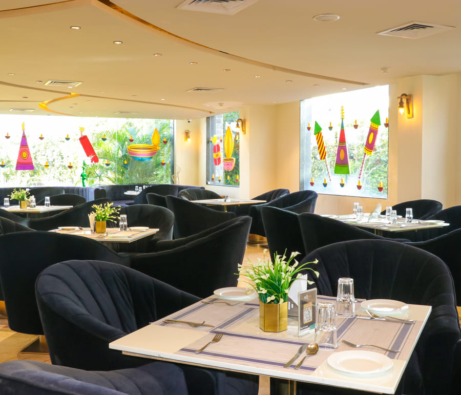 Zeus Restaurant, marble tables and navy velvet chairs in the fine-dining room