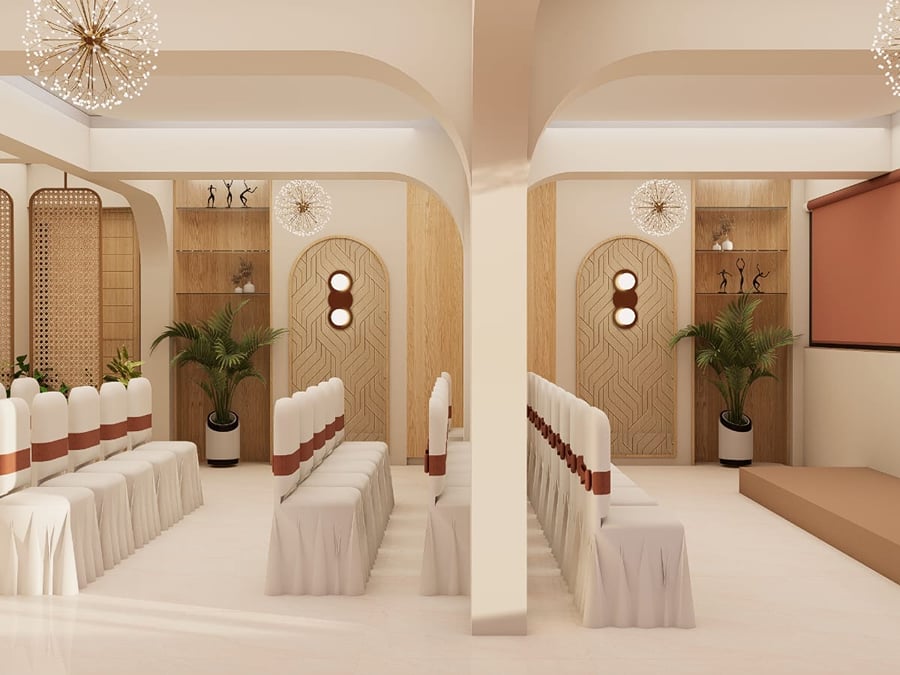 Banquet room under warm wall lighting with a clear central floor | Shirgaonkar Beach Resort
