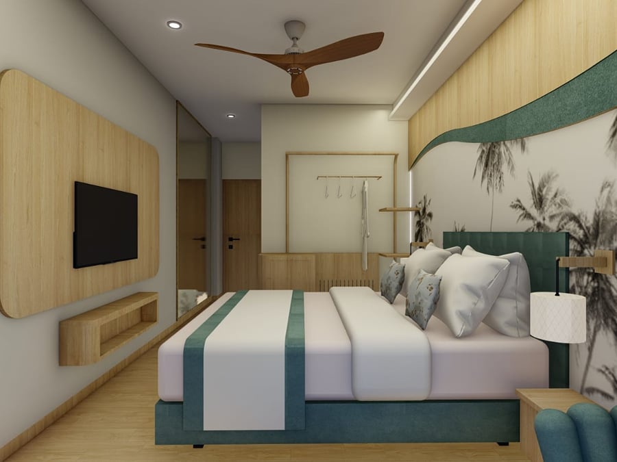 Television set into a curved wood panel opposite the bed, with a mirrored wardrobe alongside | Shirgaonkar Beach Resort