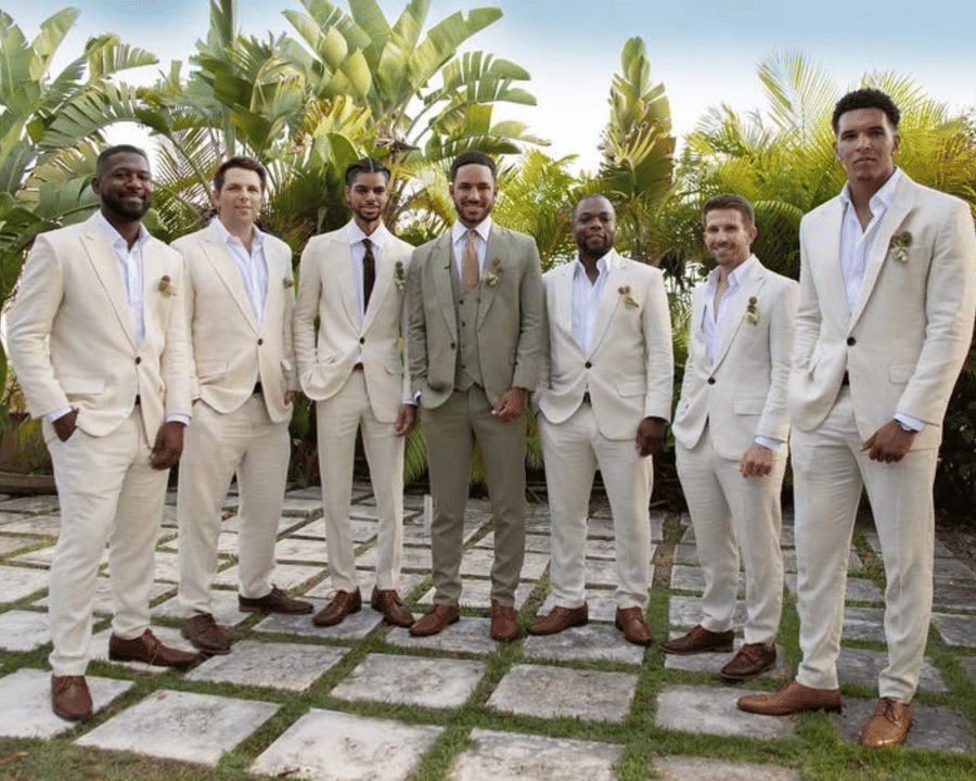 The groom and groomsmen in linen suits in the tropical garden at A Stone's Throw Away