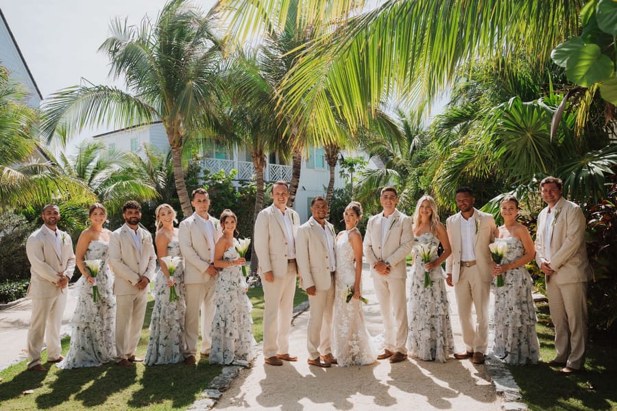 The wedding party gathered under the palms at Abaco Inn