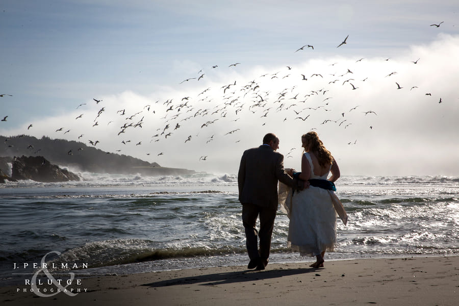 A couple walking on the beach at Mendocino Bay