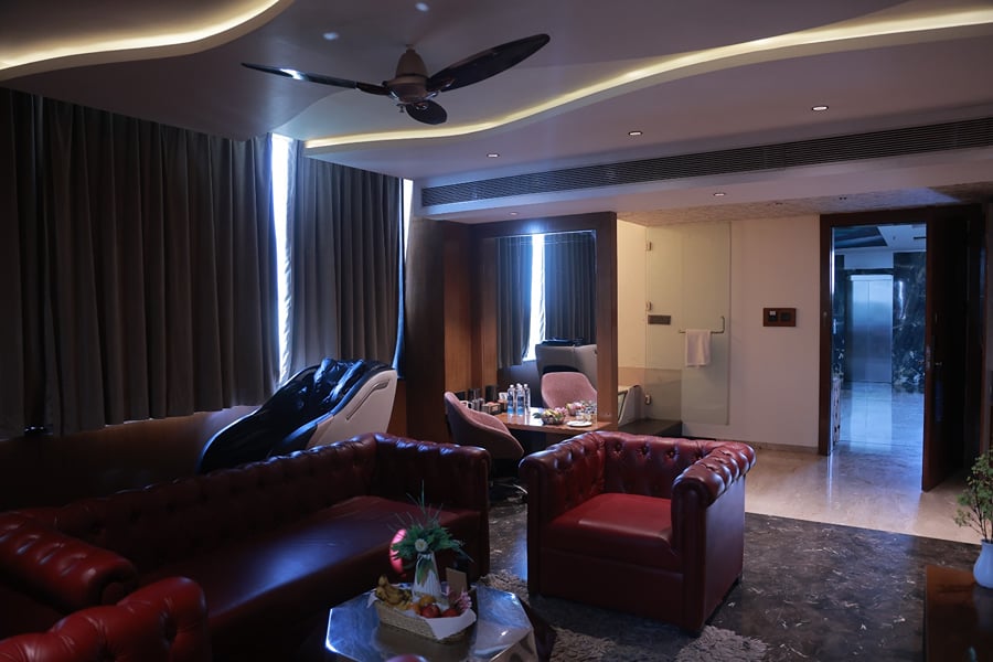 Sky Suite living area with tufted leather sofas around a coffee table
