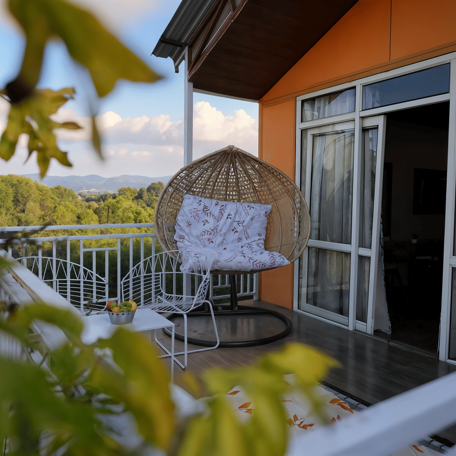 Luxurious Cottage private balcony at Nazaara Nature Retreat with wooden seating overlooking green Dalhousie valley hills
