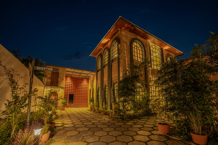 The entrance facade and reception signage at Nazaara Hills Retreat, Udaipur, pictured from the driveway.