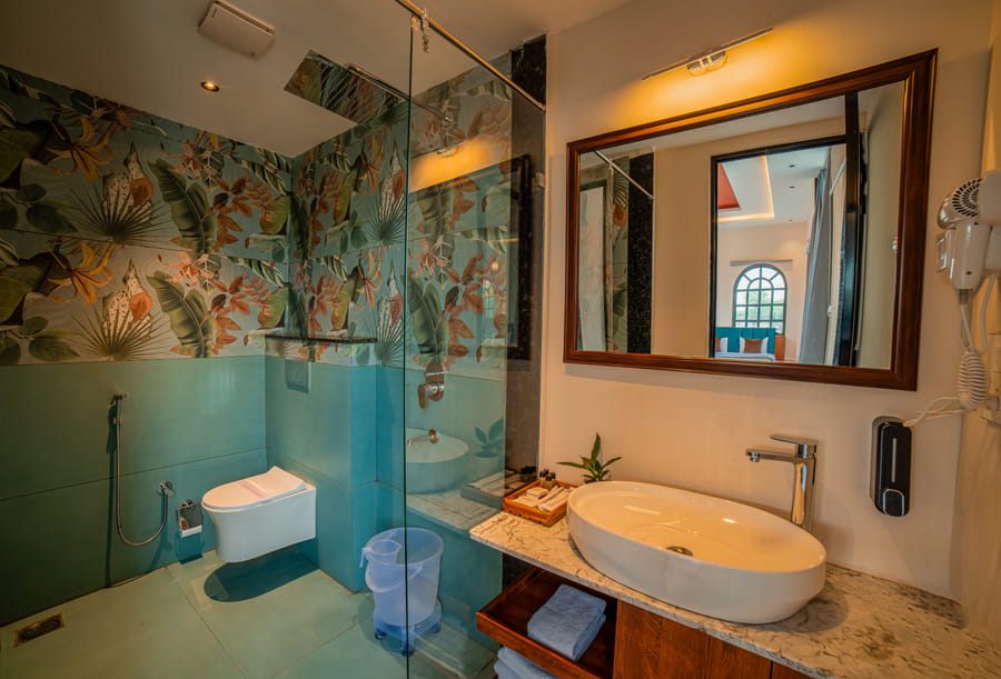 Bathroom with floral wallpaper in the Nazaara Family Suite at Nazaara Hills Retreat, Udaipur.