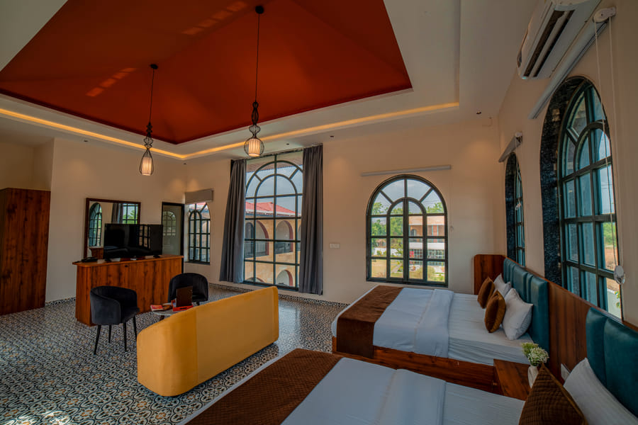 Bedroom and TV console in the Nazaara Family Suite at Nazaara Hills Retreat, Udaipur