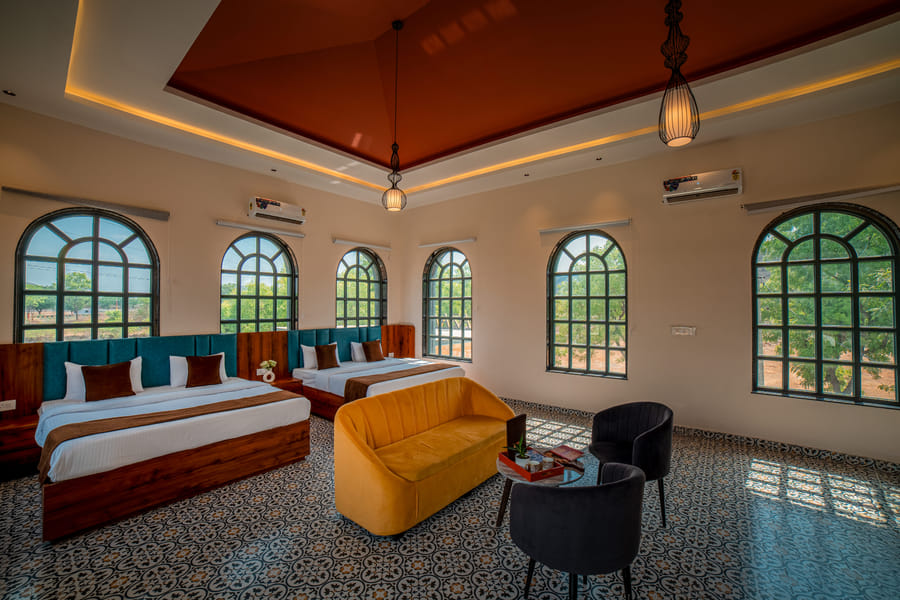 Lounge area beside a window in the Nazaara Family Suite at Nazaara Hills Retreat, Udaipur
