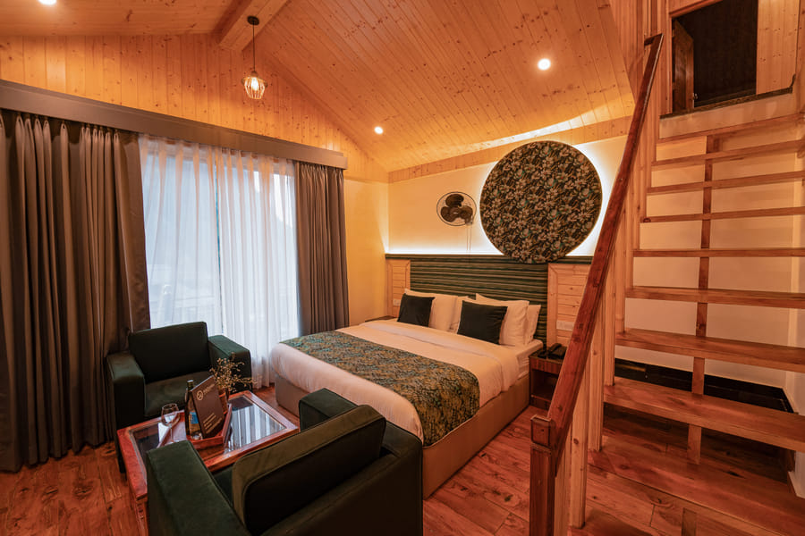 Nazaara Luxe Duplex bedroom, lounge and staircase to the loft level at Nazaara Luxe Retreat, Manali