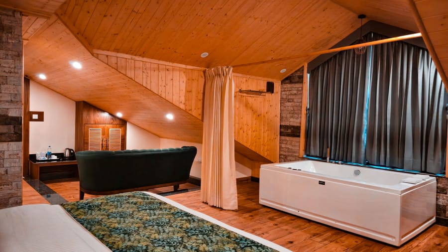 View of the Jacuzzi tub from the bedroom of the Nazaara Luxe room at Nazaara Luxe Retreat, Manali