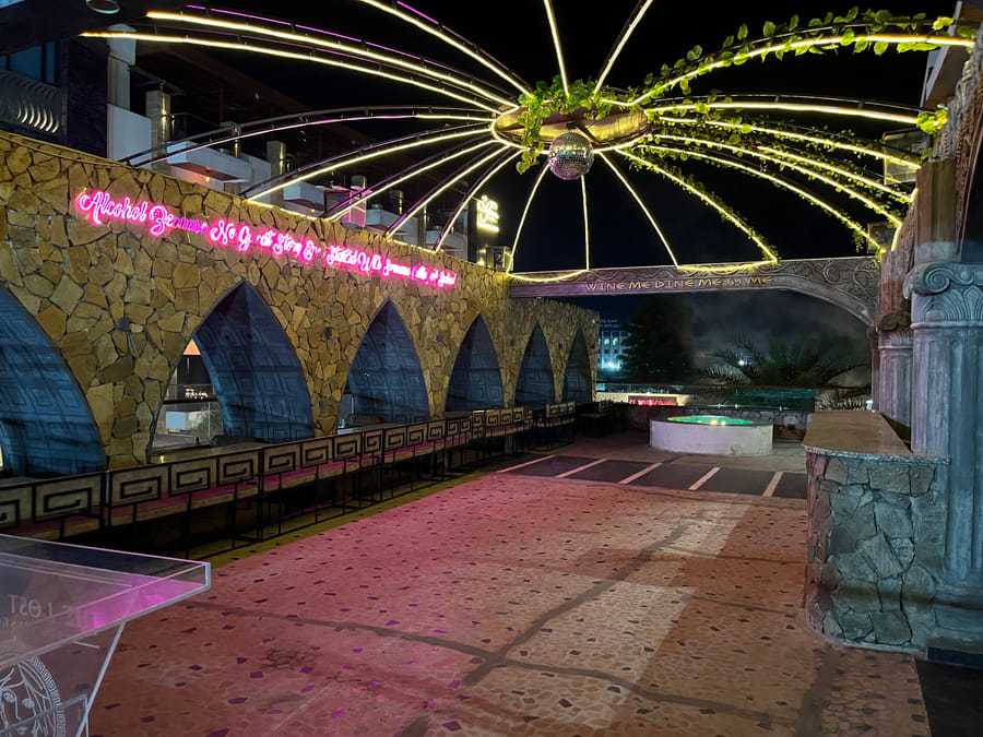 Lost Heaven, the neon-lit disco canopy above the stone arches