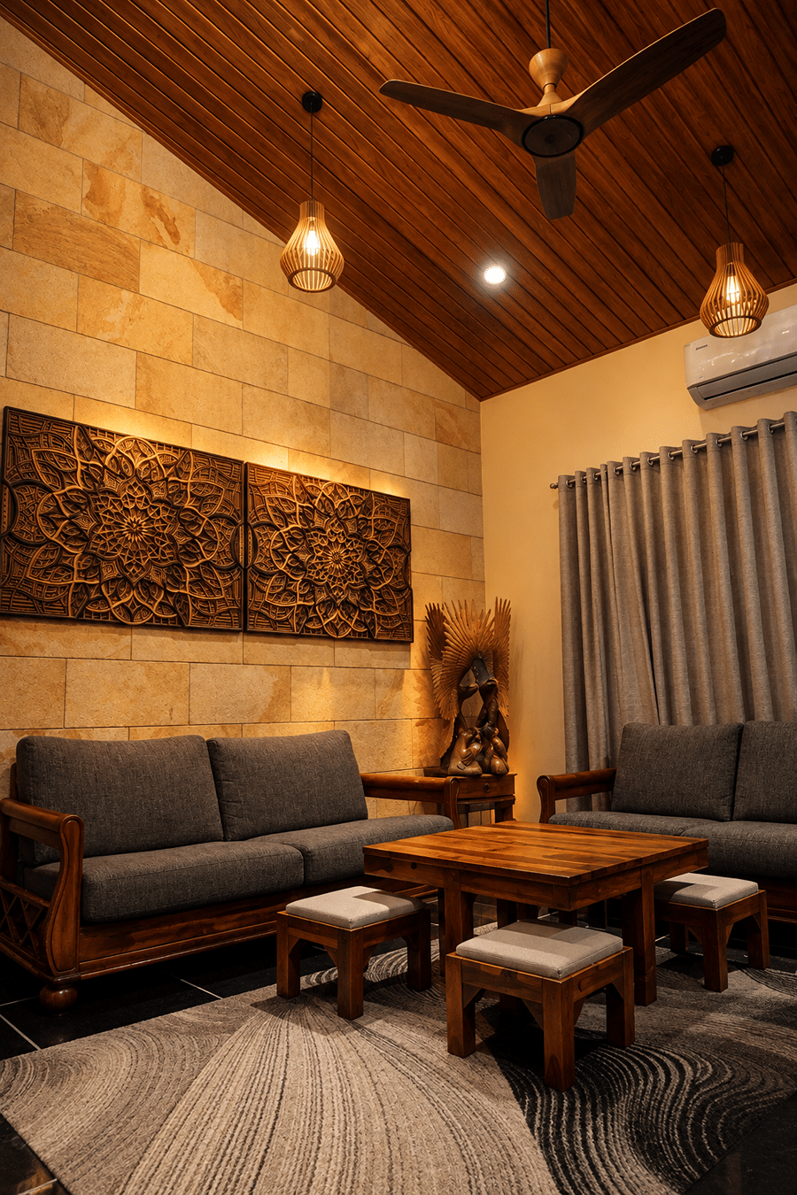 Grey sofas around a low teak table beneath a vaulted wooden ceiling and carved mandala panels at The Garud Forest, Tadoba